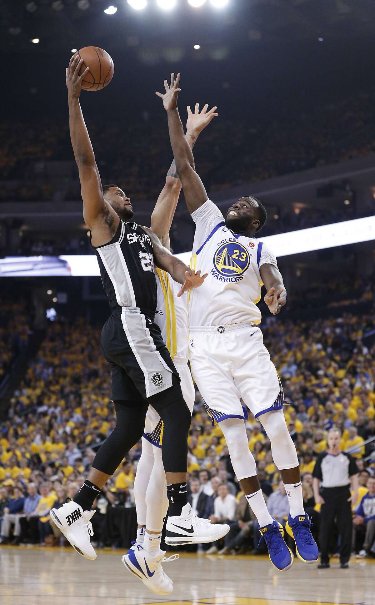 Golden State Warriors' Draymond Green defends against San Antonio Spurs' Rudy Gay in the first quarter during game 5 of round 1 of the Western Conference Finals at Oracle Arena on Tuesday, April 24, 2018 in Oakland, Calif.