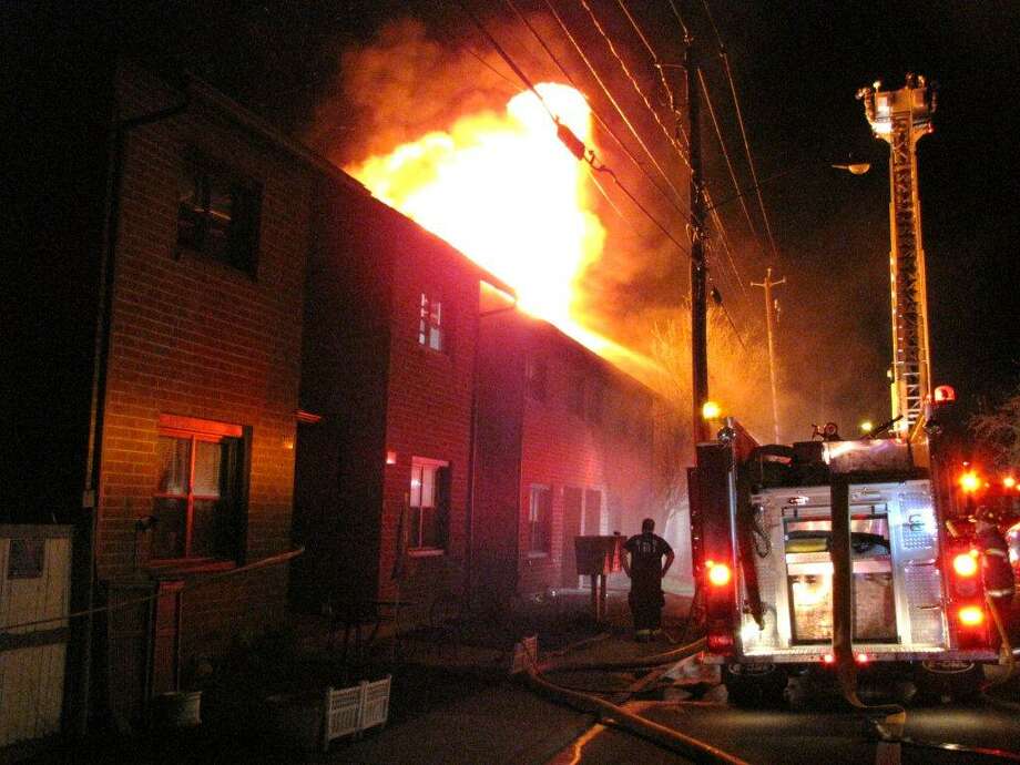 A public housing unit on First Street in Rensselaer was destroyed by fire on Tuesday night, police said. The unit, which was engulfed in flames, contained five apartments. All of the residents escaped without injury. Photo: Martin Miller
