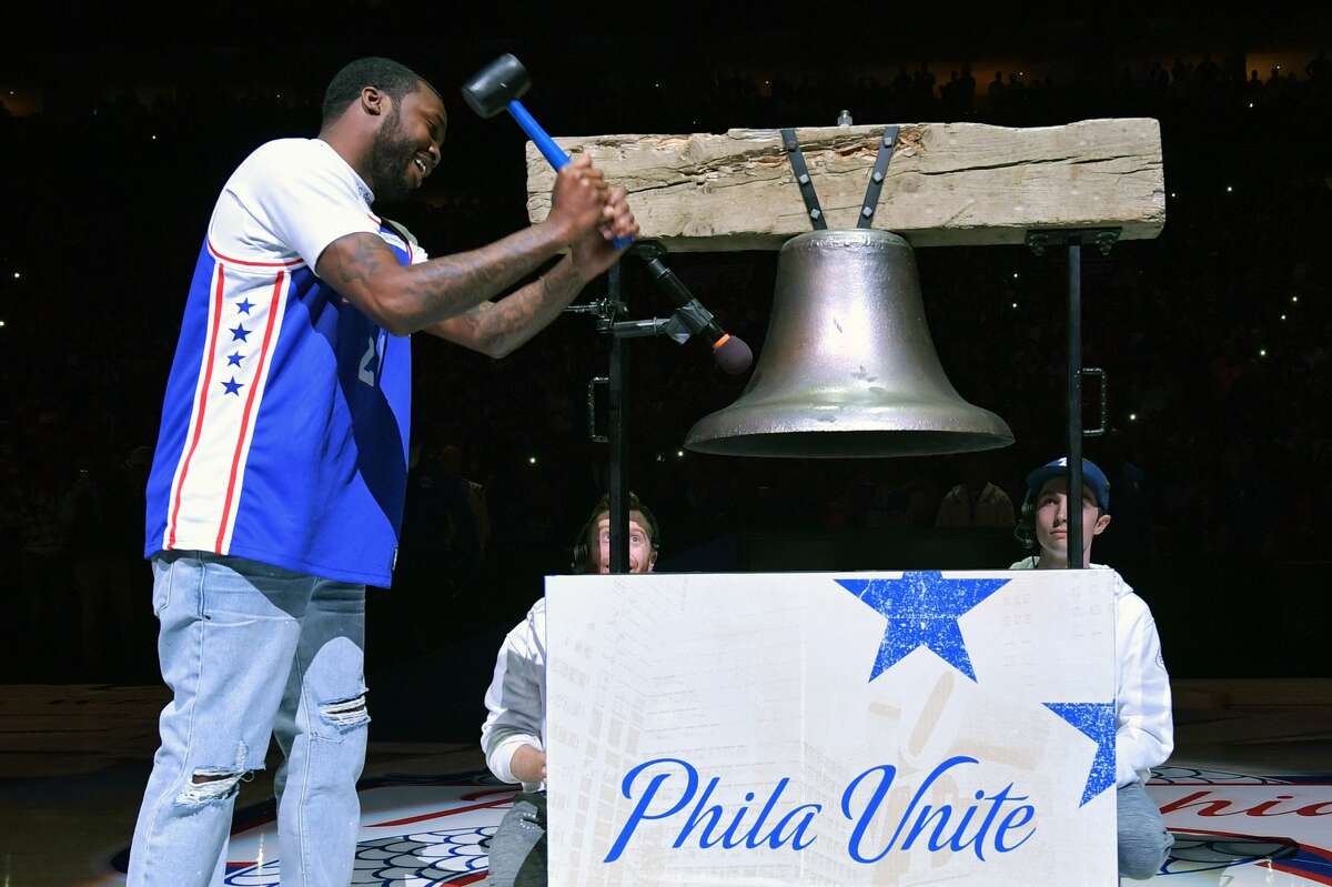 Entertainer Meek Mill rings a replica Liberty Bell before the game between the Philadelphia 76ers and Miami Heat at Wells Fargo Center on April 24, 2018, in Philadelphia.