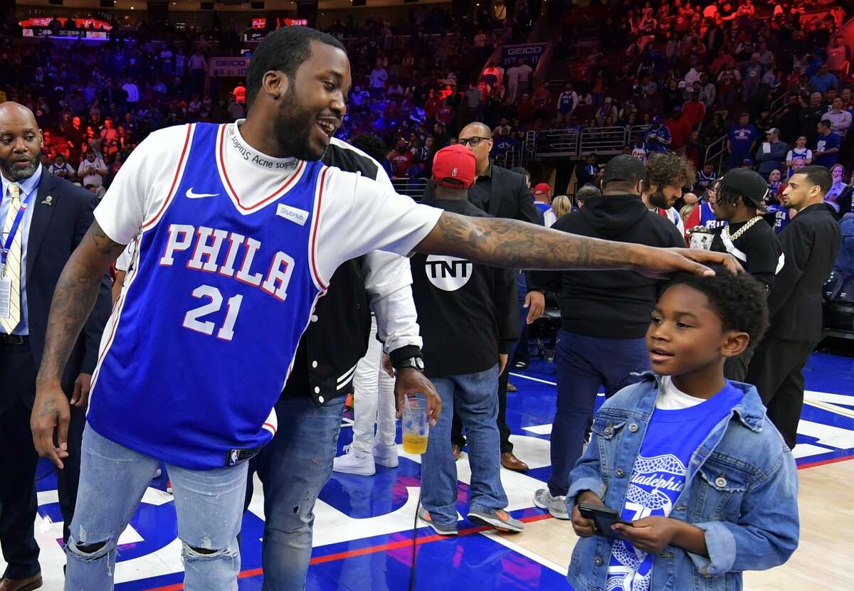 Entertainer Meek Mill stands with his son Papi at halftime during the game between the Miami Heat and Philadelphia 76ers at Wells Fargo Center on April 24, 2018, in Philadelphia.
