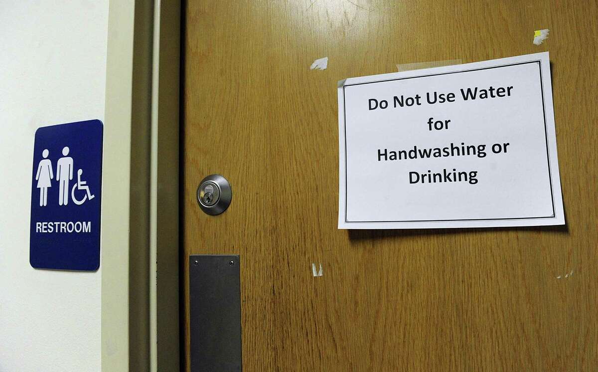 A sign on a restroom door at the Student Center at Western Connecticut State University's midtown campus, warns against using unsafe water, Wednesday, April 25, 2018.