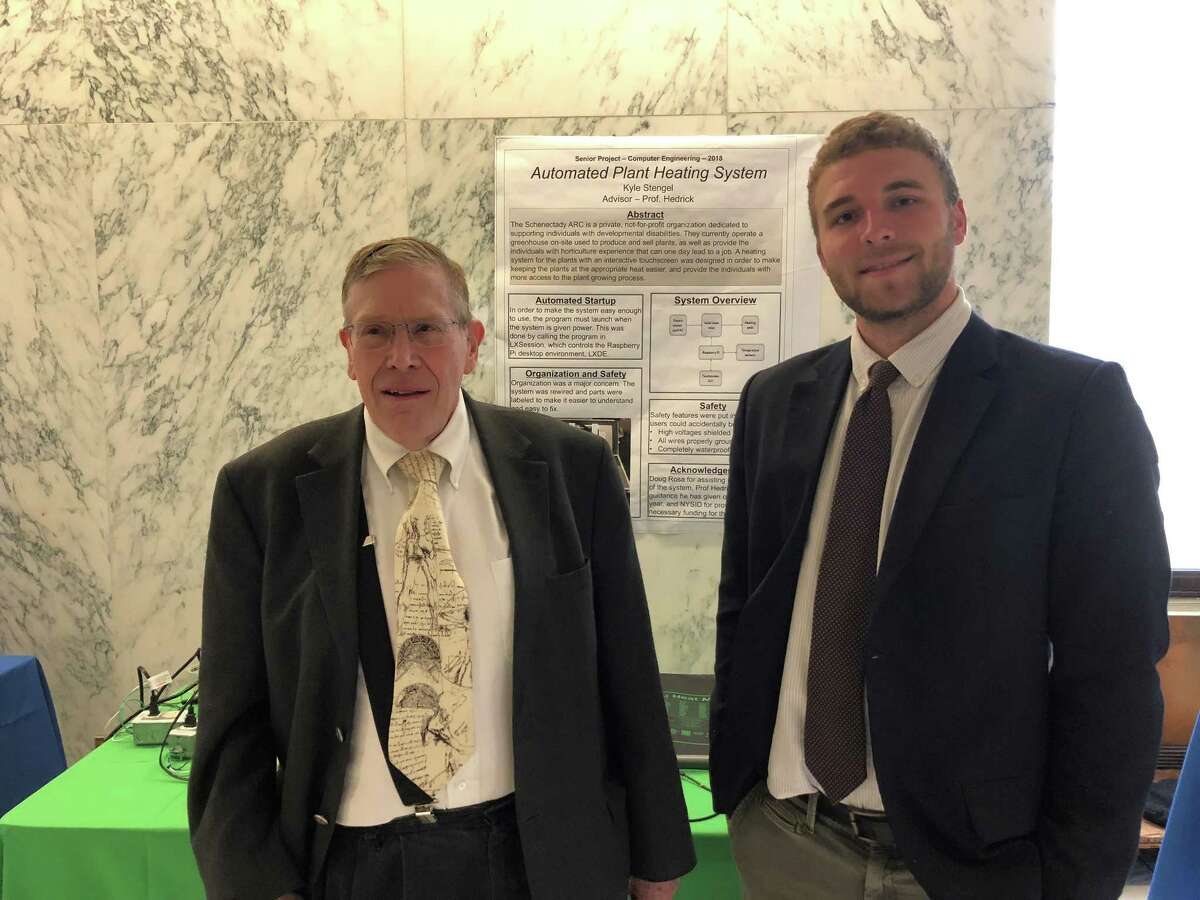 Union College professor James Hedrick, left, and computer engineering senior Kyle Stengel present their automated plant heating system at the annual CREATE symposium, held at the Legislative Office Building on State Street in Albany. (Jennifer Patterson / Times Union)