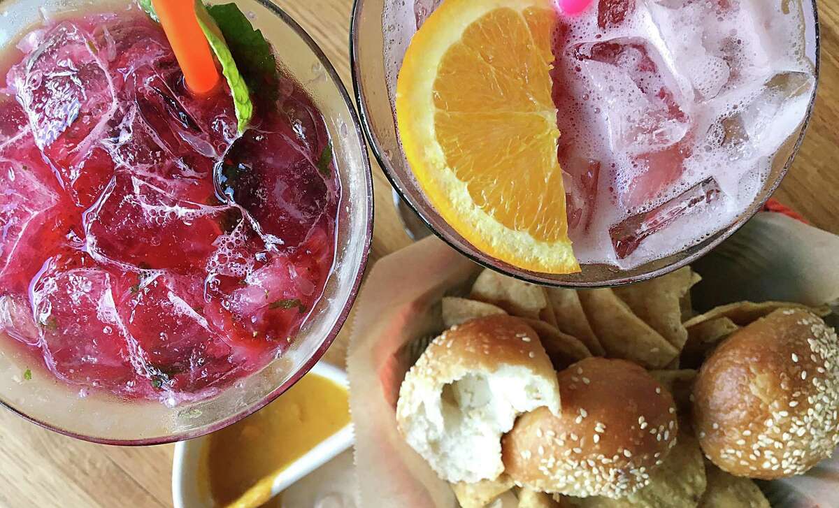 Strawberry jamaica mojito, left, Clement sangria and a basket of chips and cream cheese rolls from Villa Rica.