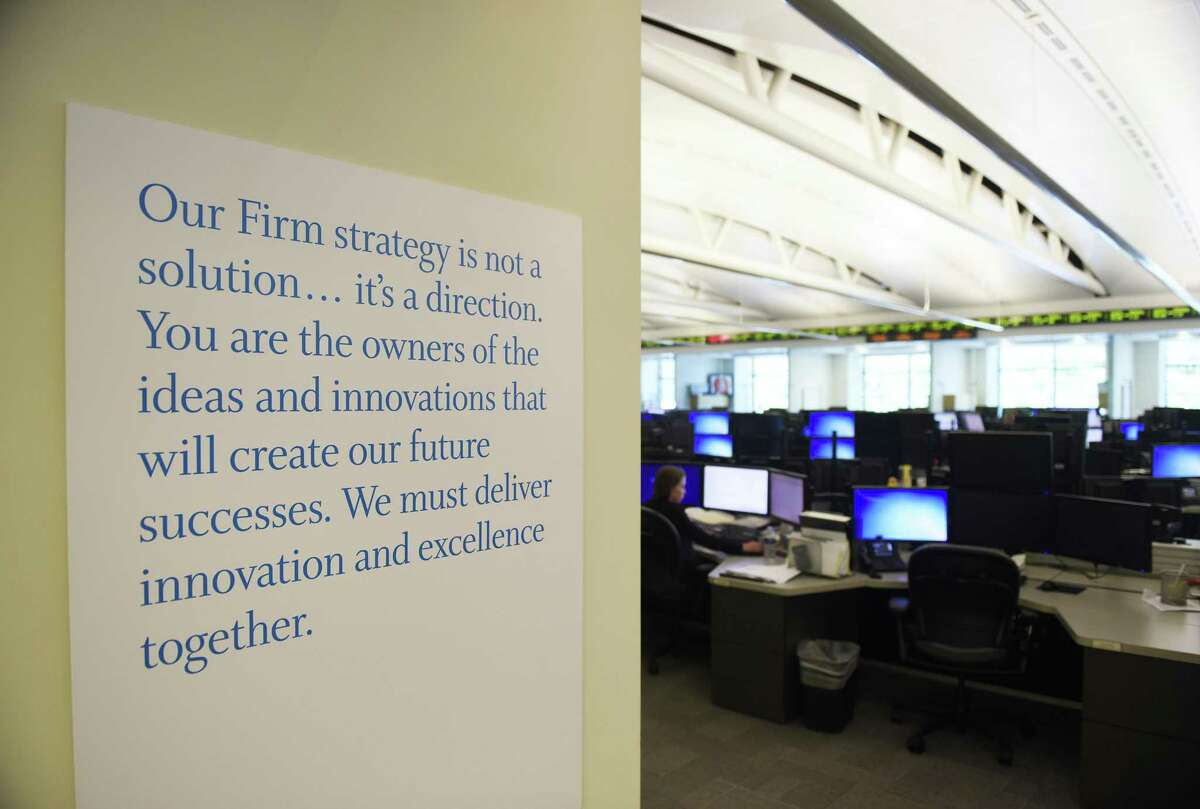 A company slogan hangs on the wall of the trading floor at Point72 Asset Management's global headquarters in Stamford, Conn.