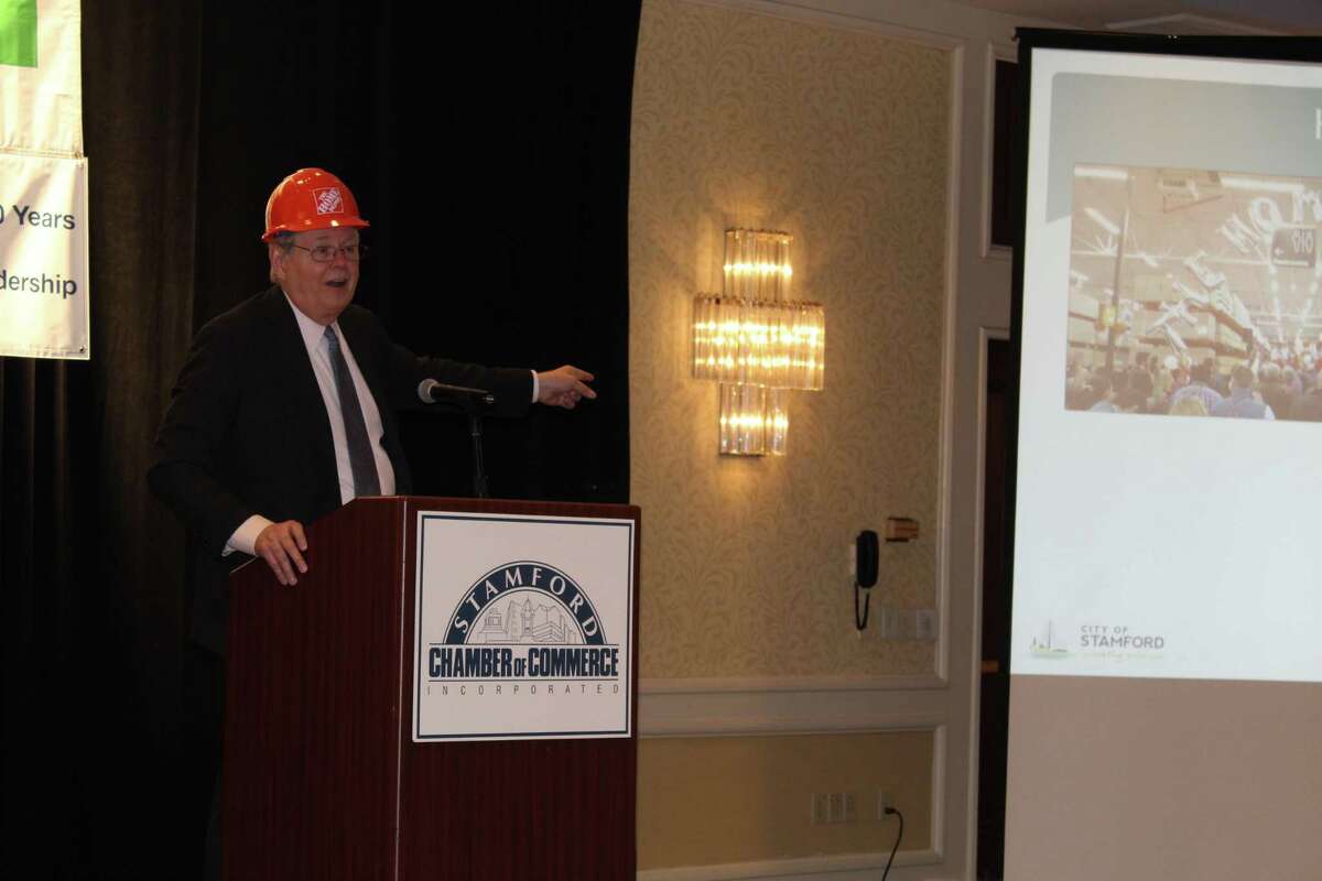 Stamford Mayor David Martin, wearing a Home Depot hard hat to recognize the store’s opening in the city, delivers his state-of-the-city address on Thursday.