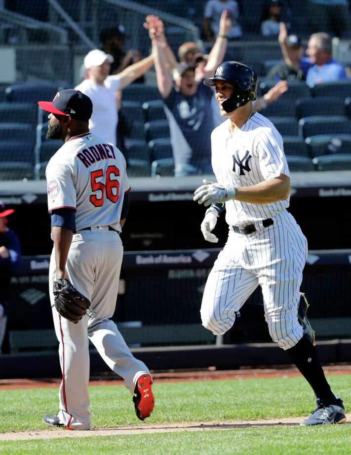 New York Yankees' Giancarlo Stanton runs past Minnesota Twins relief pitcher Fernando Rodney (56) to score on a three-run home run by Gary Sanchez during the ninth inning of a baseball game Thursday, April 26, 2018, in New York. The Yankees won 4-3. (AP Photo/Frank Franklin II) Photo: Frank Franklin II / Copyright 2018 The Associated Press. All rights reserved.