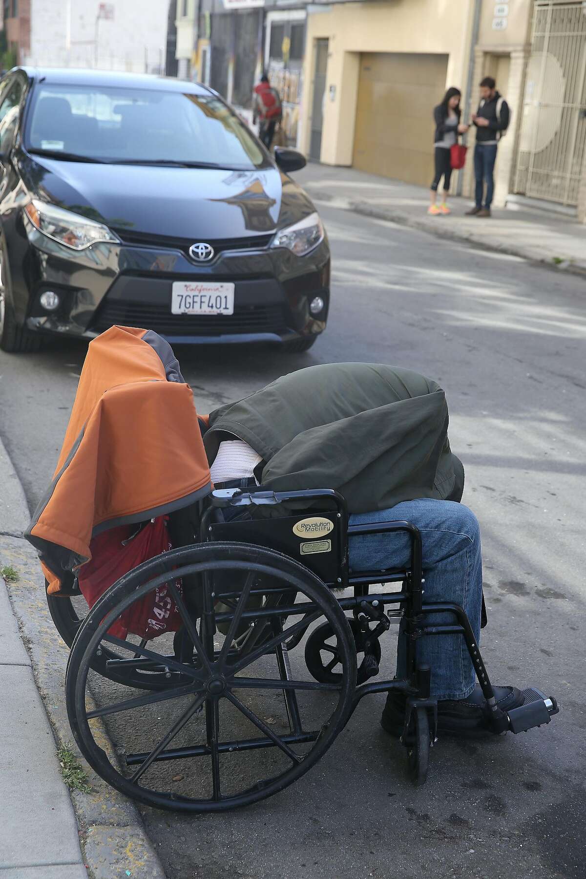 A man sleeping in his wheel chair on Natoma St. on Friday, April 20, 2018, in San Francisco, Calif. City Hall has taken decisive action on scooters plaguing SOMA sidewalks, but has taken little action on homeless, drug use, and feces woes such as this man.