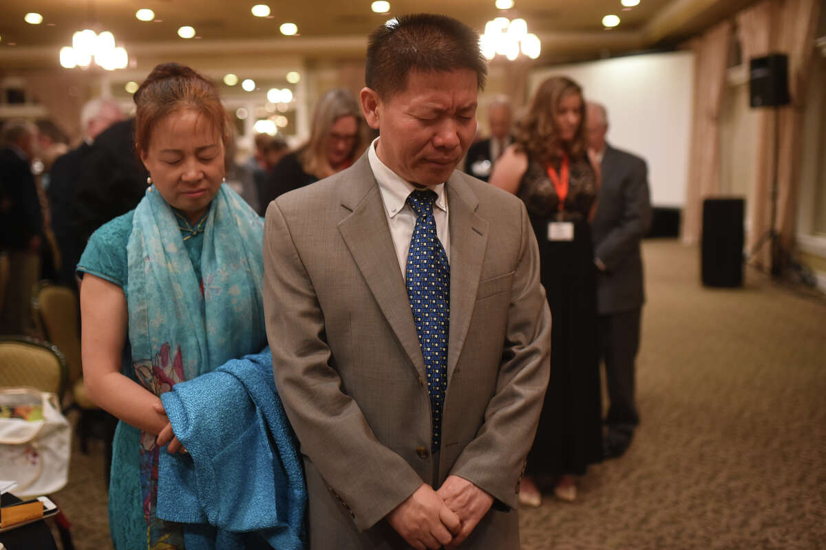 Bob and Heidi Fu pray together during the ChinaAid banquet April 26, 2018, at Midland Country Club. James Durbin/Reporter-Telegram