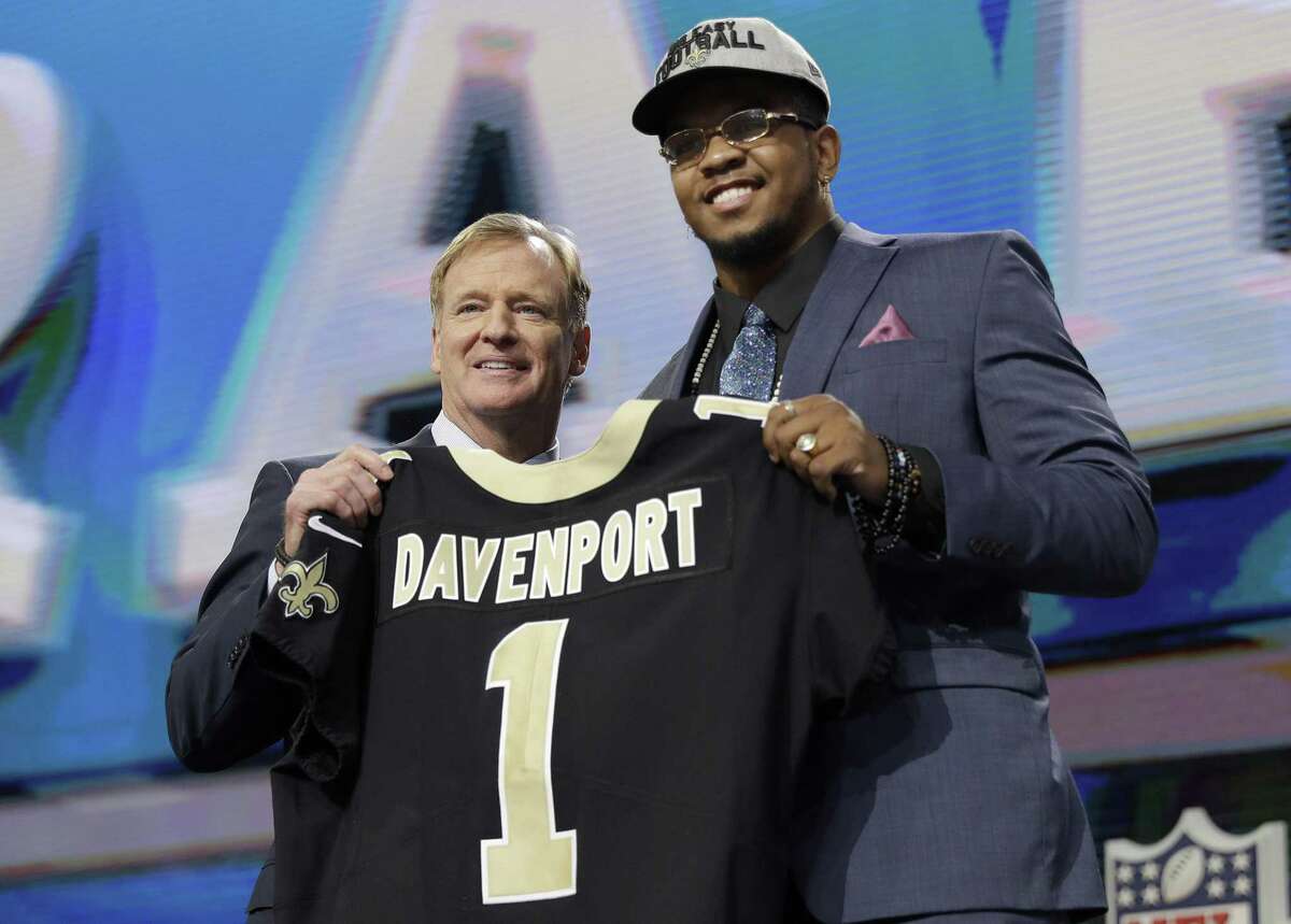 Commissioner Roger Goodell presents UTSA’s Marcus Davenport with his New Orleans jersey during the first round in Arlington.