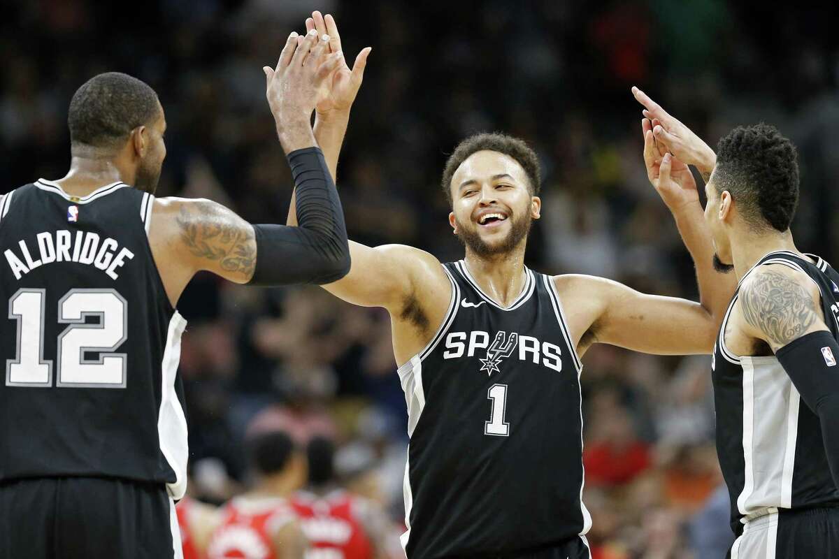 San Antonio Spurs?• Kyle Anderson celebrates with teammates LaMarcus Aldridge (left) and Danny Green after a basket during second half action against the Houston Rockets Sunday April 1, 2018 at the AT&T Center. The Spurs won 100-83.