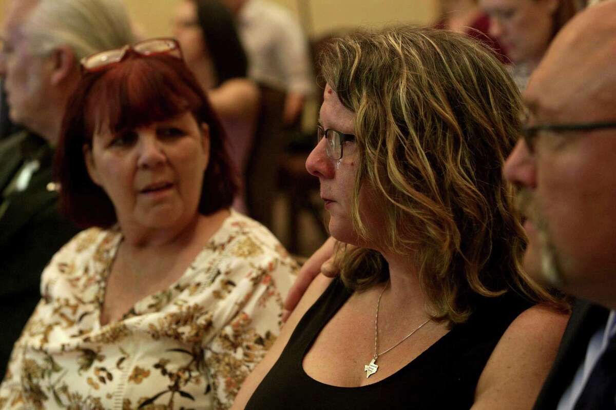 Tears stream down the face of Sherri Pomeroy, center, with her husband, pastor Frank Pomeroy, and sister, Sylvia Timmons, left, during the press conference announcing the new building plans for First Baptist Church of Sutherland Springs at the Hilton San Antonio Airport on Tuesday, March 27, 2018. Pomeroy was thinking of her friend, Karla Holcombe, who walked the grounds next to the church for years praying for God to provide the funds for the church to buy the property. Holcombe was killed at the church Nov. 5.