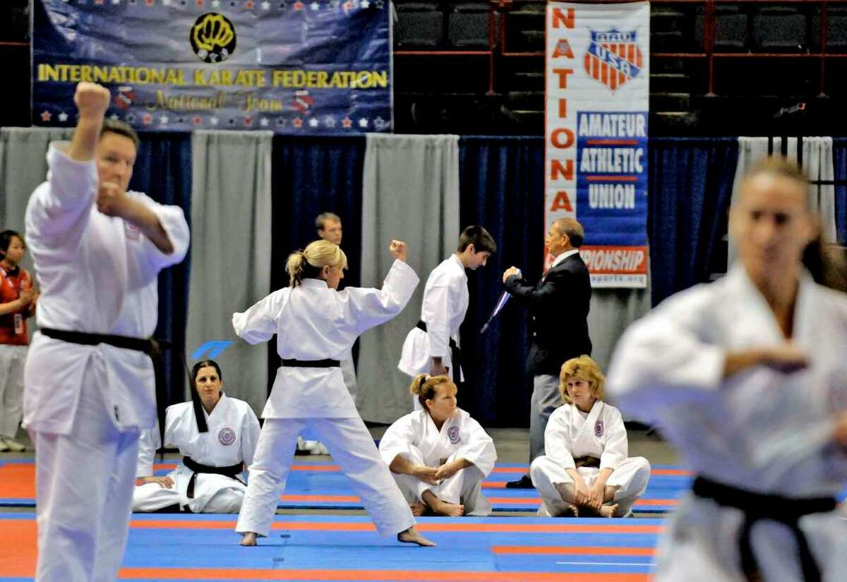 Competitors in the Kata event go through their routines as part of the Amateur Athletic Union National Karate Championship at the Times Union Center in Albany. ( Michael P. Farrell / Times Union )