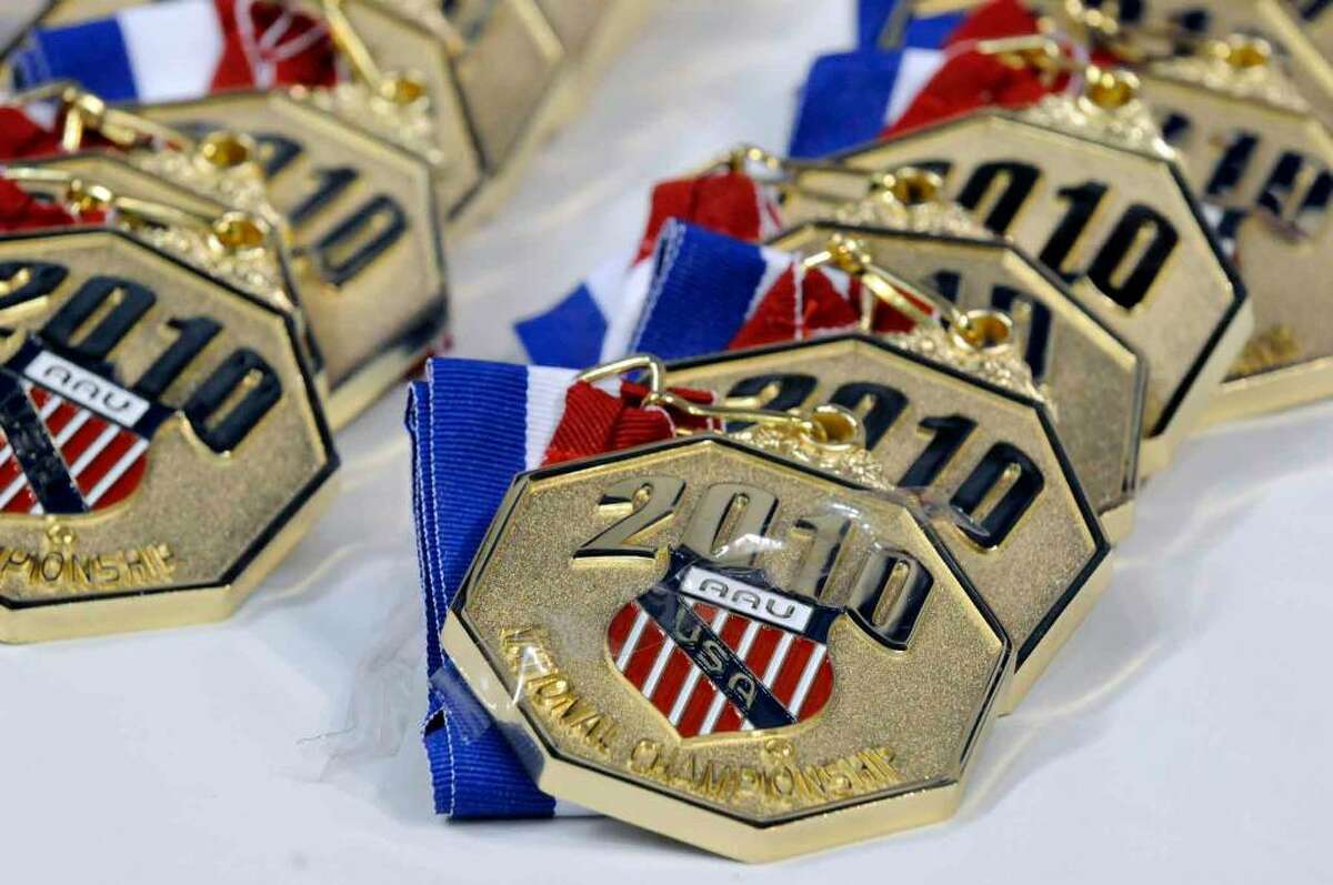 Gold medals yet to be awarded in the Amateur Athletic Union National Karate Championship sit on a table at the Times Union Center. The event includes about 1,600 athletes and ends Saturday. ( Michael P. Farrell / Times Union