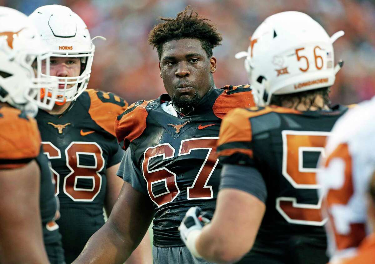 Tope Imade (67) takes a break with teammates at the UT Orange-White Spring Game at DKR Stadium on April 21, 2018.