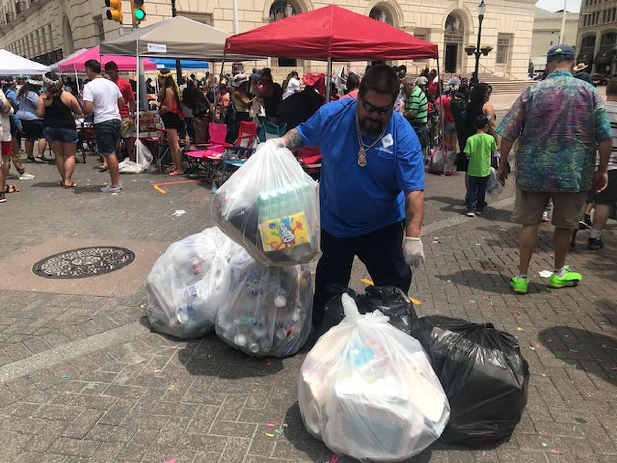 Trash bags piled up on downtown San Antonio streets following the Battle of Flowers parade on April 27, 2018.