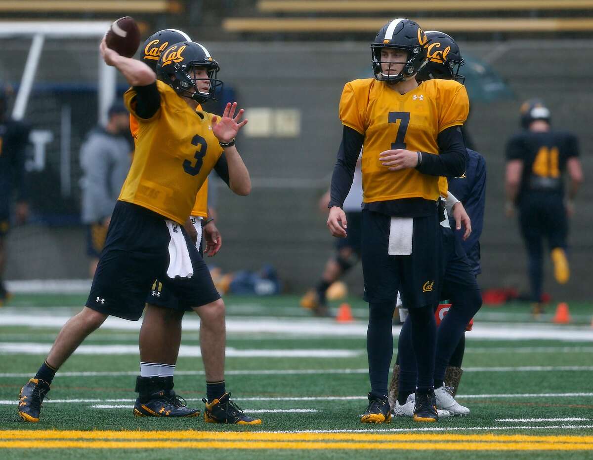 Quarterback Ross Bowers (3) and Chase Garbers (7) participate in a passing drill during a Cal Bears football practice in Memorial Stadium at UC Berkeley on Friday, April 6, 2018.