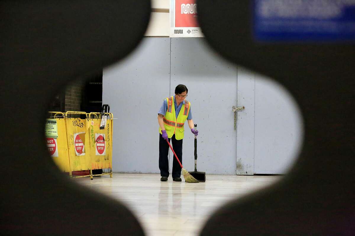 A worker is seen sweeping through the gates at a fare entrance in the Civic Center / UN Plaza Station on Friday, April 27, 2018 in San Francisco, Calif.