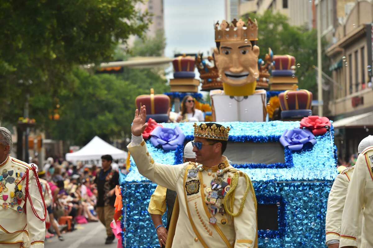 Rey Feo, Ken Flores, waves to the crowd along Commerce St. during the Battle of Flowers Parade Friday.
