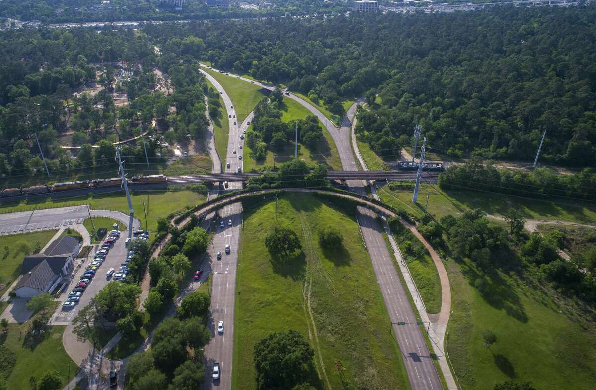 This Wednesday, April 25, 2018 photo, shows the current pedestrian bridge that crosses Memorial Drive on the west side of Memorial Park in Houston. The Kinder Foundation, a charitable organization established by Richard Kinder, co-founder of energy company Kinder Morgan, and his wife Nancy are donating $70 million to the Memorial Park Conservancy.