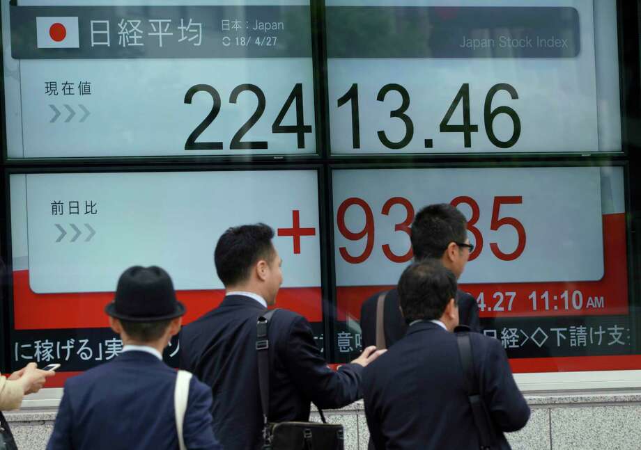 Men walk past an electronic stock board showing Japan's Nikkei 225 index at a securities firm in Tokyo Friday, April 27, 2018. Asian stock markets followed Wall Street higher on Friday after reports of strong U.S. earnings, as investors watched the inter-Korean summit. (AP Photo/Eugene Hoshiko) Photo: Eugene Hoshiko / Copyright 2018 The Associated Press. All rights reserved.