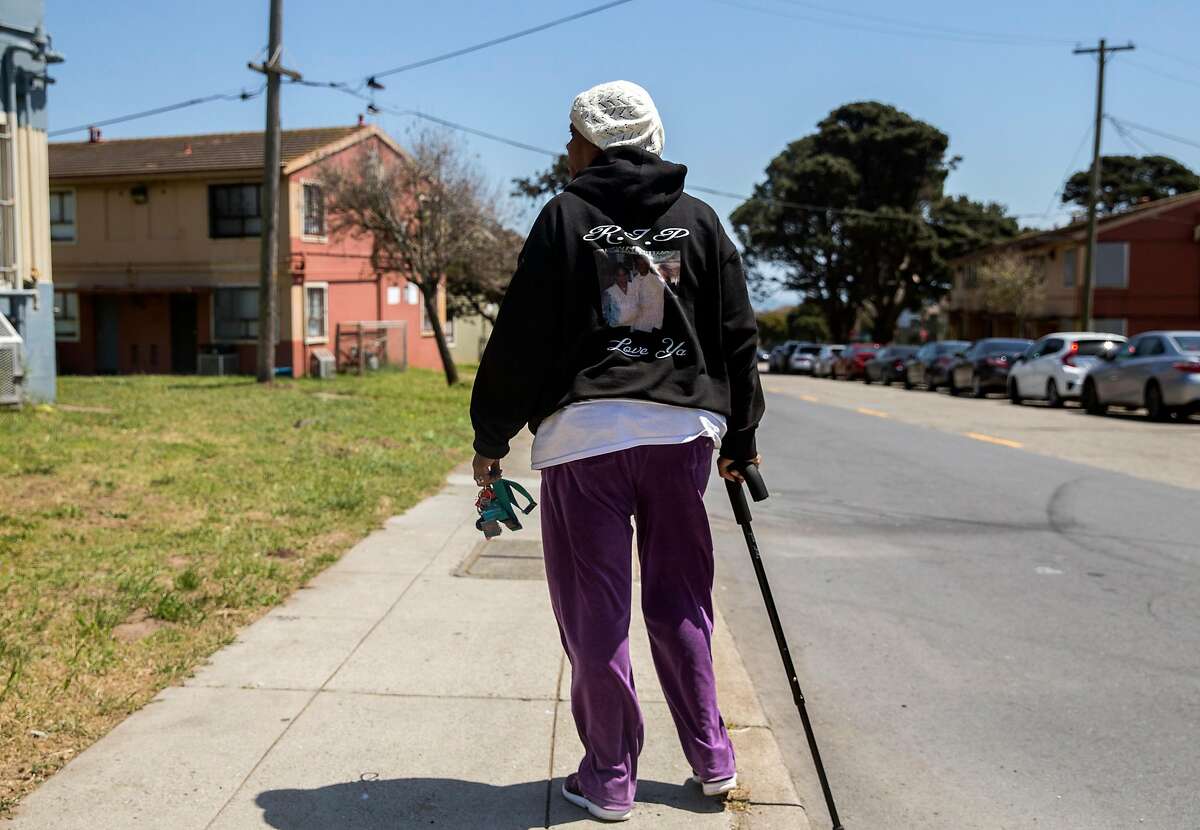 Carla Ellis, 58, walks down Sunnydale Avenue while wearing a sweatshirt memorializing her son who was killed at the hand of gang violence in Richmond, Calif. in 2004 seen Wednesday, April 25, 2018 in the Sunnydale neighborhood of San Francisco, Calif.