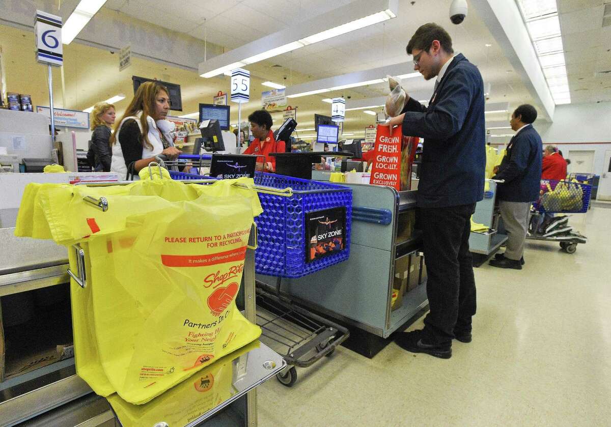 Jason Najera, a customer service agent at ShopRite, steps in to help bag a customers order on April. 27, 2018. The store on Stamford' Westside is one of 11 owned and operated by Cingari family. It is hoping customers will be spurred to bring their own reusable bags as Stamford's Board of Representatives look to draft an ordinance that would prohibit the use of non-recyclable plastic bags. The store was offering a free reusable bag to shoopers this weekend.