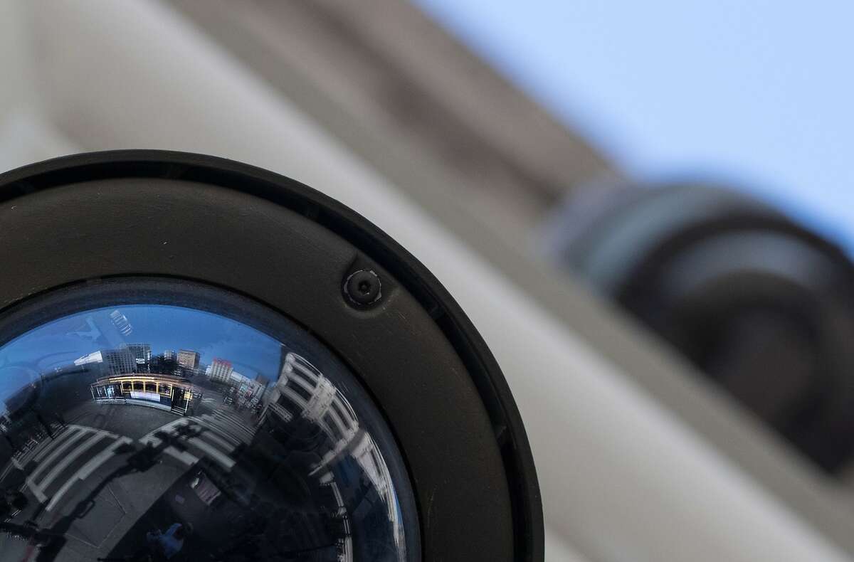 A cable car is reflected in a CCTV camera mounted along Powell Street in San Francisco.