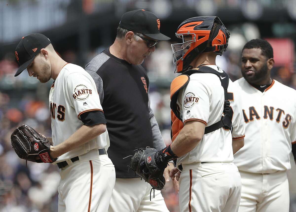 San Francisco Giants pitcher Chris Stratton, left, walks off the mound after being relieved by manager Bruce Bochy, center left, as catcher Nick Hundley, center right, and third baseman Pablo Sandoval watch during the second inning of a baseball game against the Los Angeles Dodgers in San Francisco, Saturday, April 28, 2018. (AP Photo/Jeff Chiu)