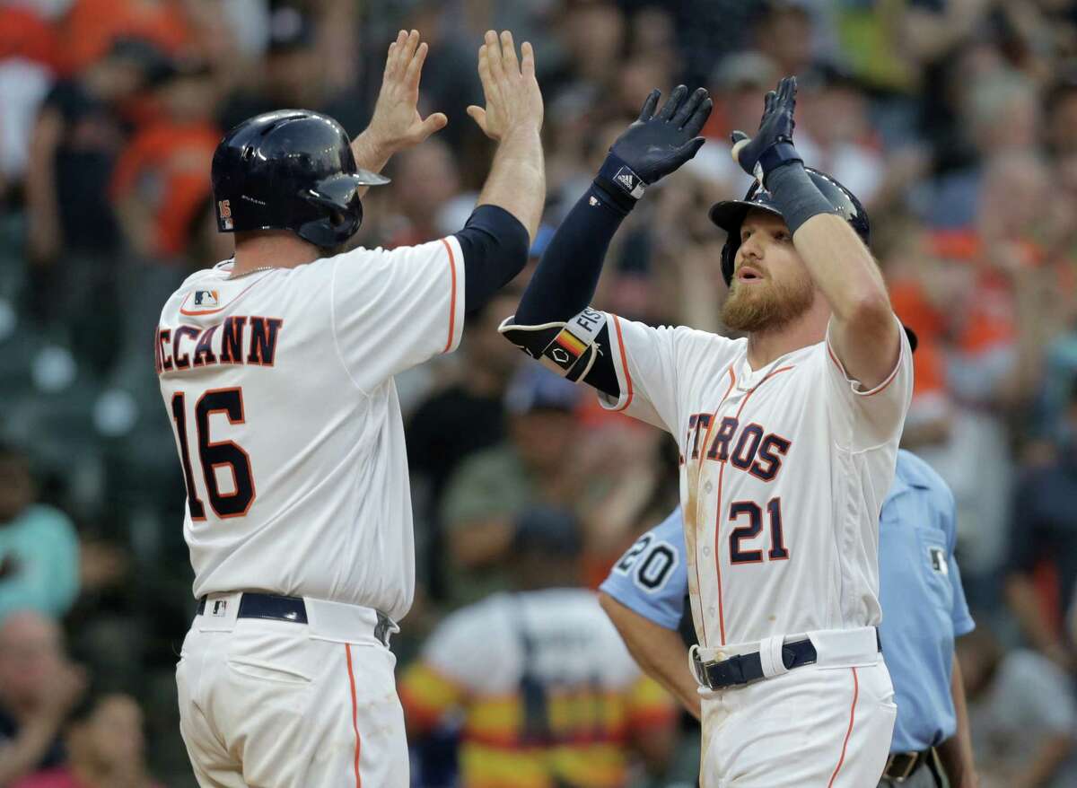 Houston Astros catcher Brian McCann (16) congratulates Derek Fisher (21) after Fisher's two-run home run in the fifth inning against the Oakland Athletics at Minute Maid Park on Saturday, April 28, 2018, in Houston. Astros are behind in the series 1-0.