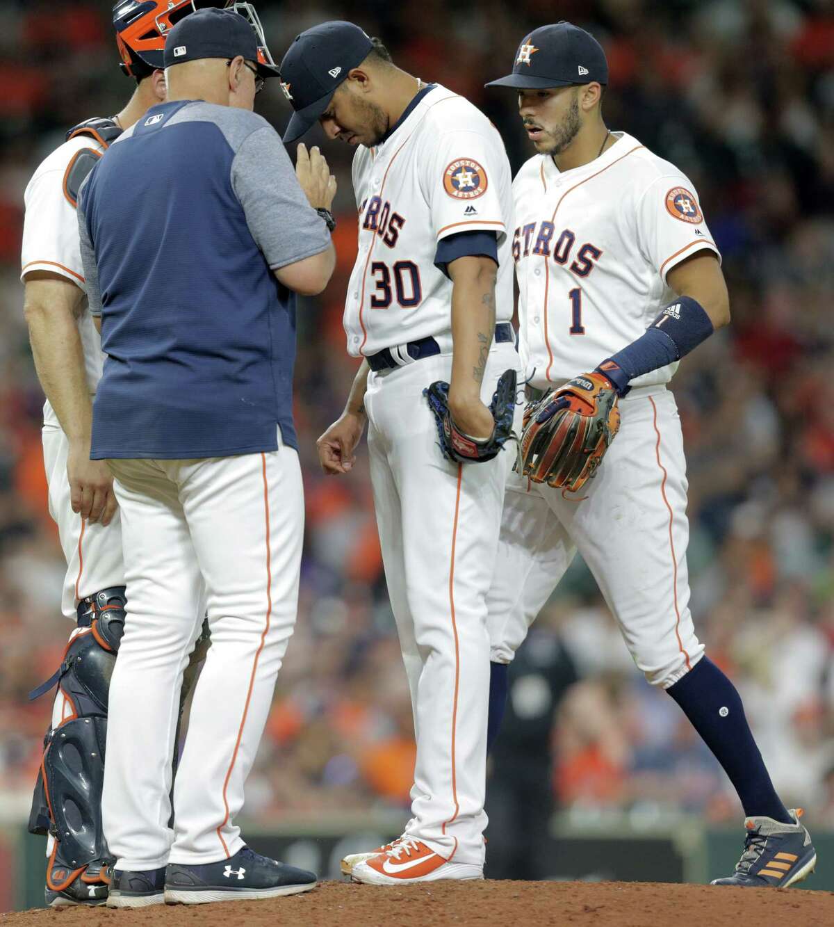 Houston Astros relief pitcher Hector Rondon (30) listens to Houston Astros pitching coach Brent Strom (56) in the eighth inning against the Oakland Athletics on Saturday, April 28, 2018, in Houston.