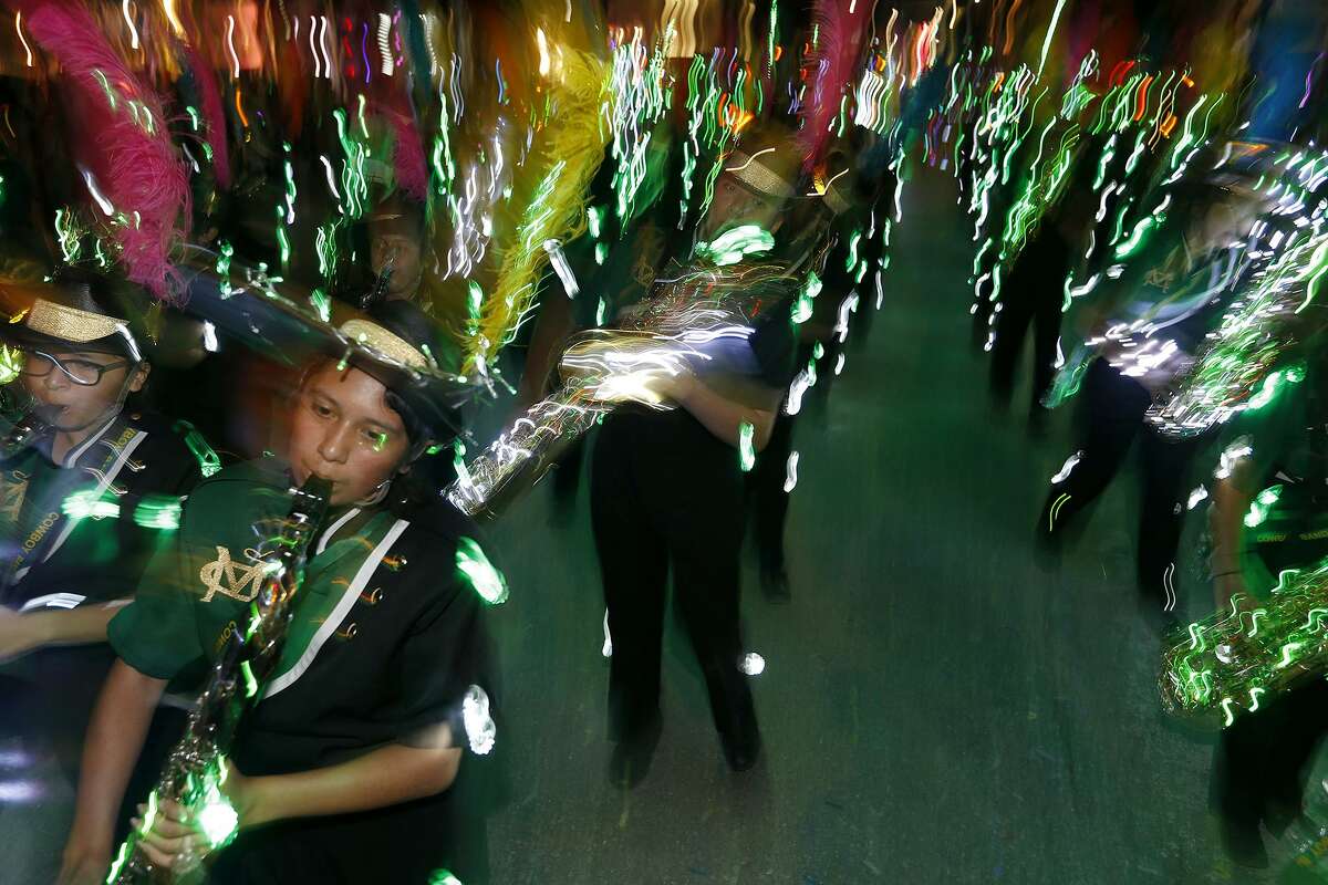 Members of the McCollum High School Cowboy Band perform during the 2018 Fiesta Flambeau Parade. While the parade officially began in 1948, the idea of an illuminated nighttime parade may have originated from sculptor Pompeo Coppini in 1905.