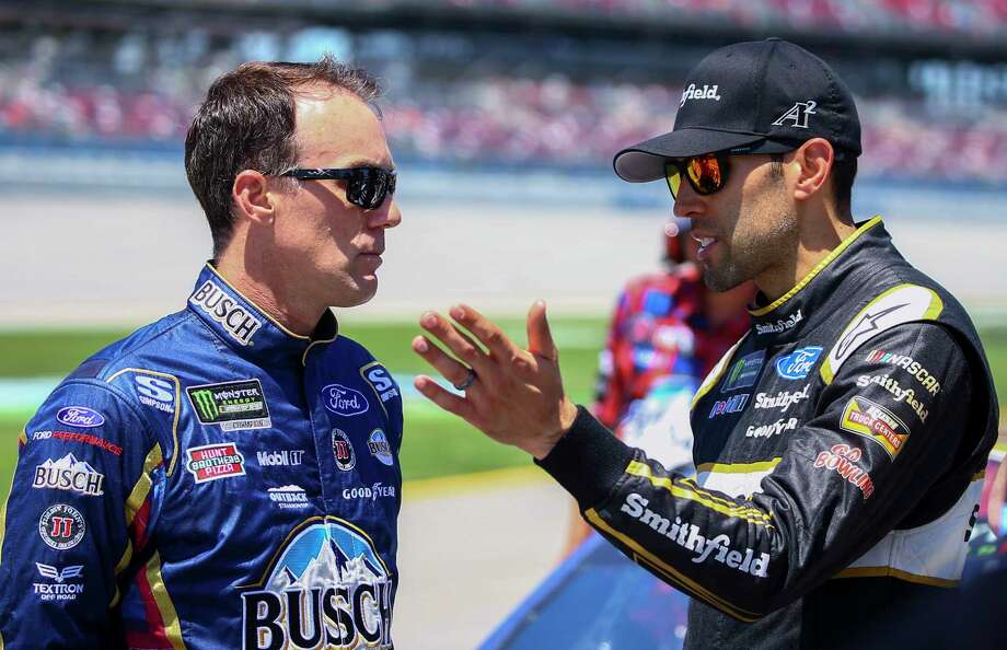 Kevin Harvick, left, talks with Aric Almirola during qualifying for the NASCAR Cup Series auto race at Talladega Superspeedway, Saturday, April 28, 2018, in Talladega, Ala. (AP Photo/Butch Dill) Photo: Butch Dill / Associated Press