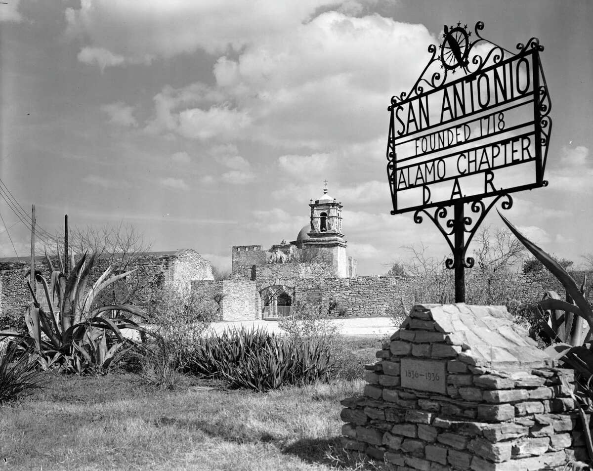 A photo of the west gate at Mission San Jose, which was the visitors’ entrance at that time. It was taken in about 1939. The sign reads “San Antonio, founded 1718. Alamo Chapter, D.A.R. (Daughters of the American Revolution).