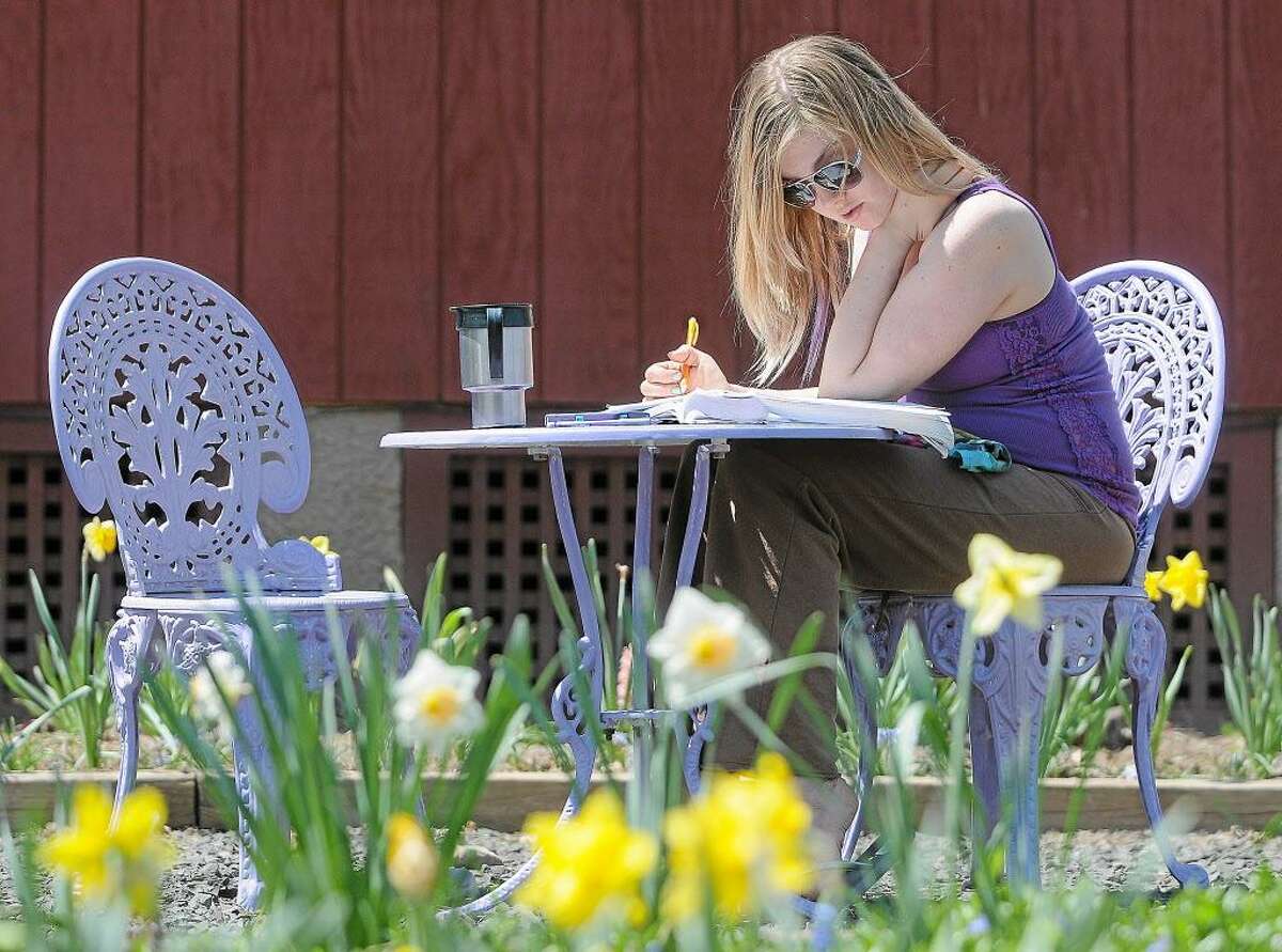 A Middlesex Community College student finishes a math assignment outdoors.