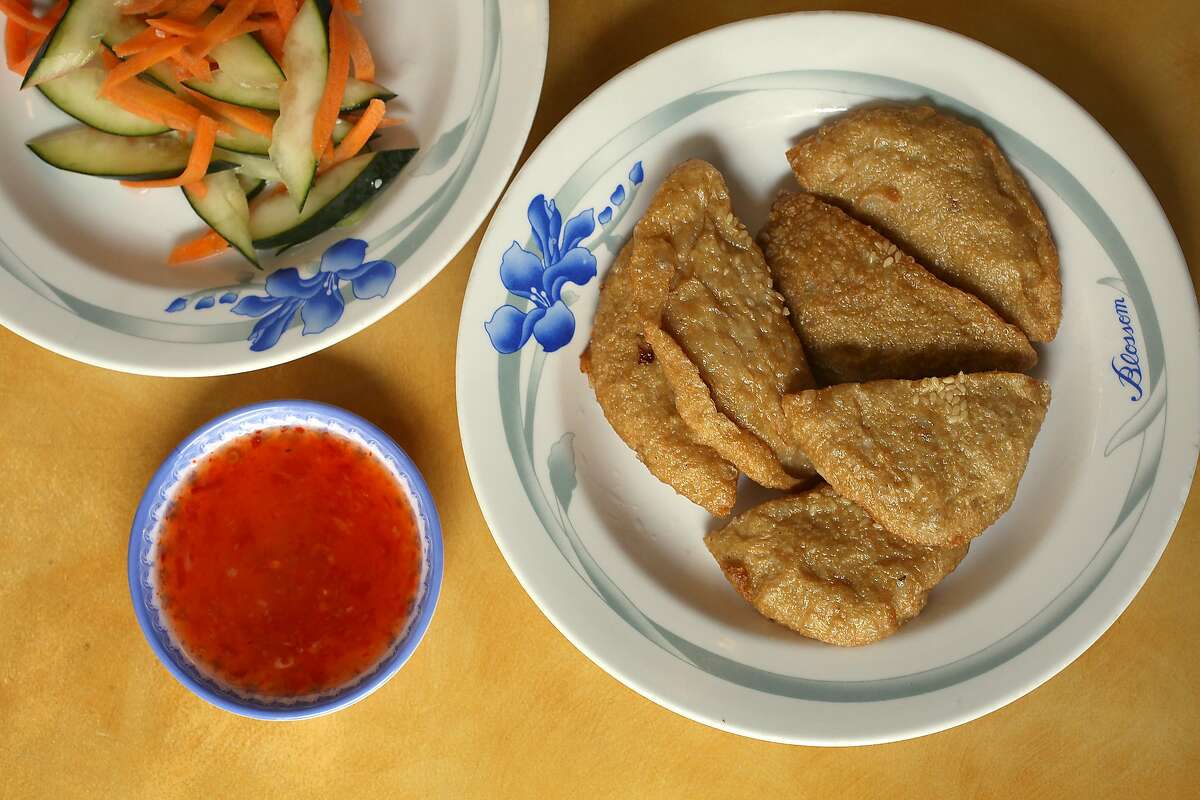 Cha Ca Chien (right)--golden fried fish cakes--with pickled vegetables (left) served at Hai Ky Mi Gia, a Vietnamese-Chinese restaurant on Friday, April 27, 2018, in San Francisco, Calif.