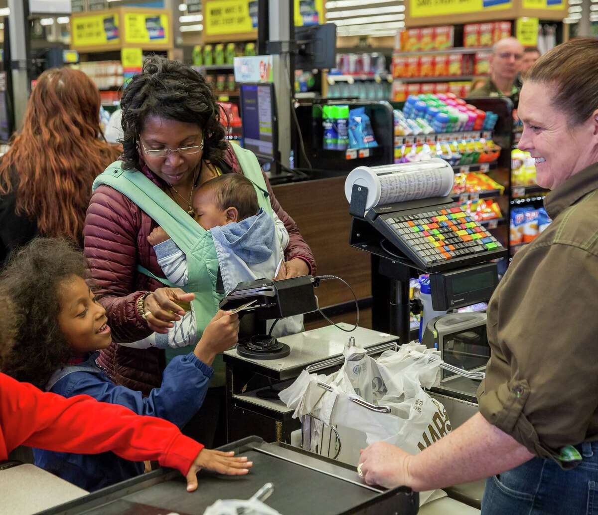 Weslene Newcomb, of Albany, tests the state's new eWIC card system at Market 32 in Albany, N.Y. on Monday, April 30, 2018. The local mom is the first New Yorker to try the card, which state health officials say is more discreet than the paper checks that have historically been used to pay for WIC foods. (Photo by Mike Wren / New York State Health Department)