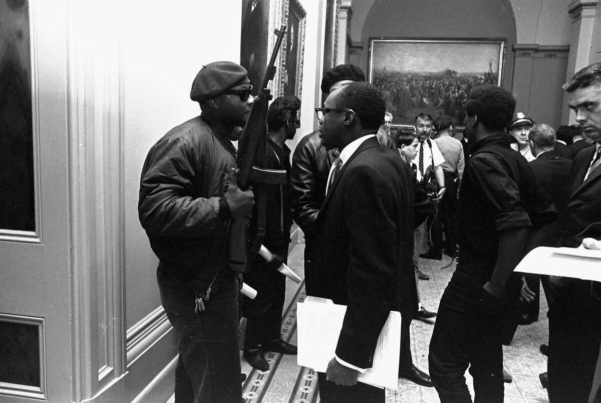 Then-Assemblyman Willie L. Brown Jr., D-San Francisco, center, talks to a Black Panther Party member May 3, 1967. They were protesting a bill before an Assembly committee restricting the carrying of loaded weapons in public.