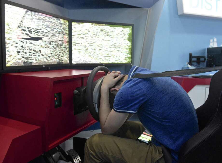 New Milford High School, junior Nick Scarcella, 16, reacts to hitting a car while texting and driving in the Arbella Insurance Foundation's distracted driving simulator at New Milford High School, in New Milford, Conn. April 30, 2018. Photo: H John Voorhees III / Hearst Connecticut Media / The News-Times