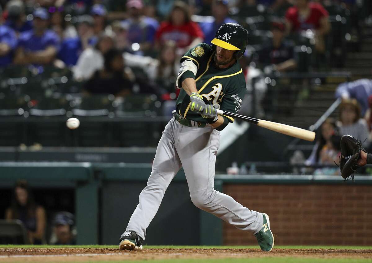 Oakland Athletics' Jed Lowrie swings at a pitch from Oakland Athletics relief pitcher Liam Hendriks in the ninth inning of a baseball game Tuesday, April 24, 2018, in Arlington, Texas. Lowrie connected for single. (AP Photo/Richard W. Rodriguez)