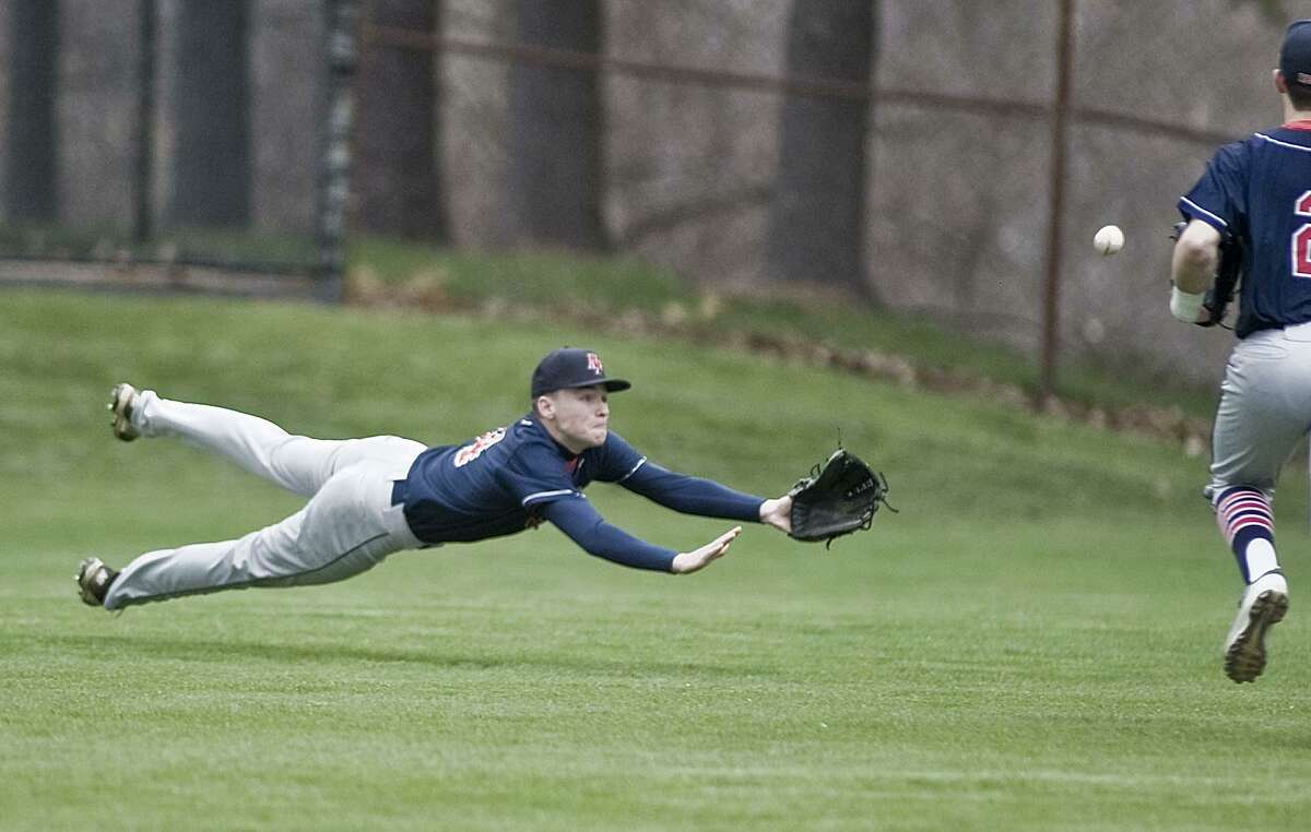 New Fairfield High School left fielder Matt Garbowski dives for a fly ball in a game against Bethel High School, played at Bethel. Monday, April 30, 2018