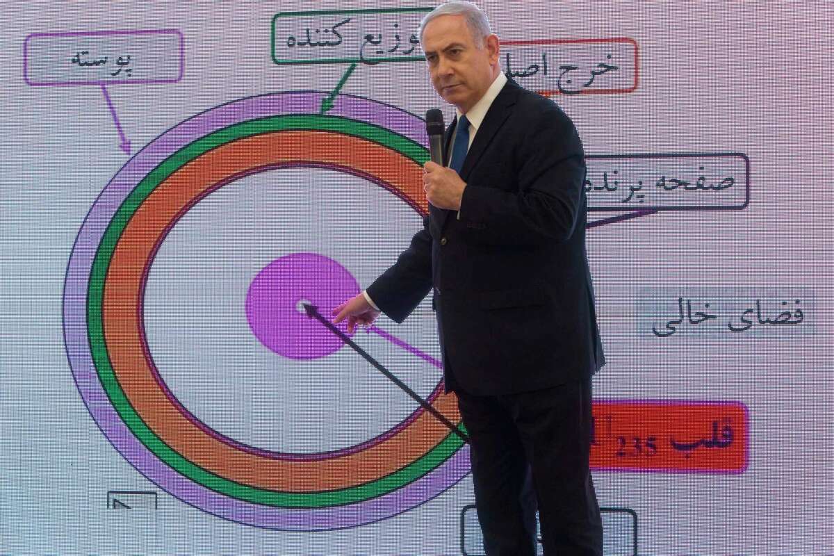 Israeli Prime Minister Benjamin Netanyahu presents material on Iranian nuclear weapons development during a press conference in Tel Aviv, Monday, April 30 2018. Netanyahu says his government has obtained "half a ton" of secret Iranian documents proving the Tehran government once had a nuclear weapons program. Calling it a "great intelligence achievement," Netanyahu said Monday that the documents show that Iran lied about its nuclear ambitions before signing a 2015 deal with world powers. (AP Photo/Sebastian Scheiner)