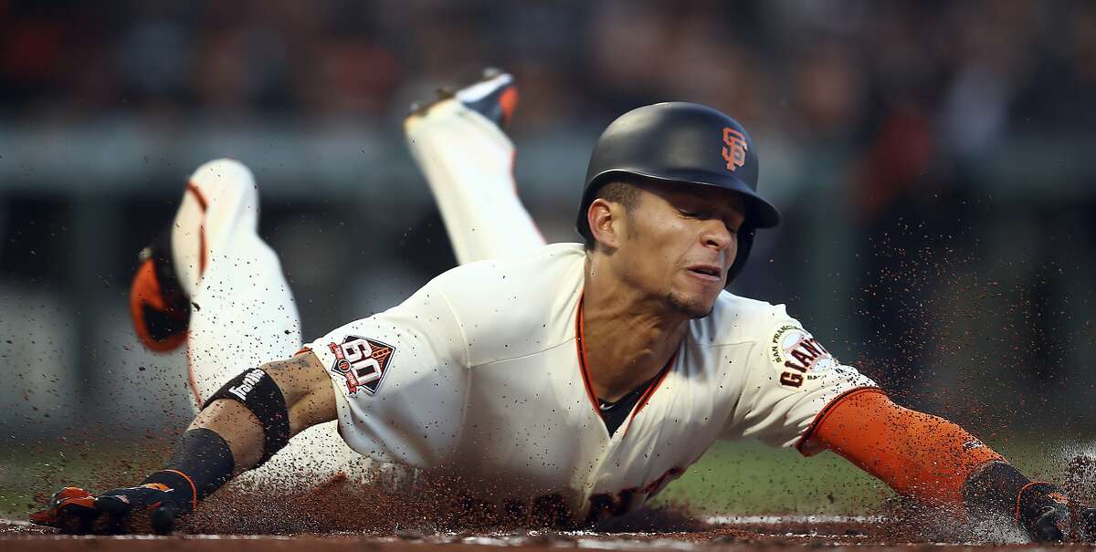 San Francisco Giants' Gorkys Hernandez slides to score against the San Diego Padres during the first inning of a baseball game Monday, April 30, 2018, in San Francisco. (AP Photo/Ben Margot)