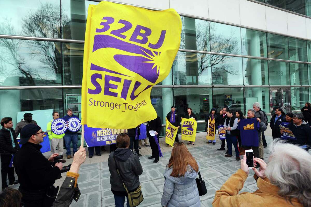 Local workers stand up for their freedom to fight for decent and equitable pay during a rally outside of Government Center in downtown Stamford, Conn. on Monday, Feb. 26, 2018.