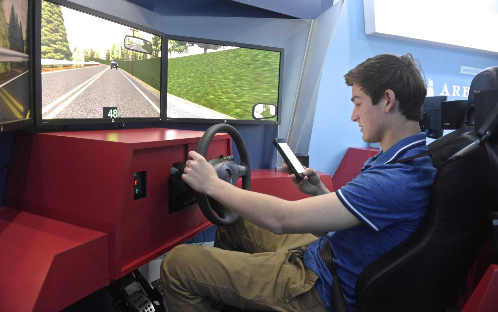 Simulator teaches dangers of distracted driving at New Milford High School