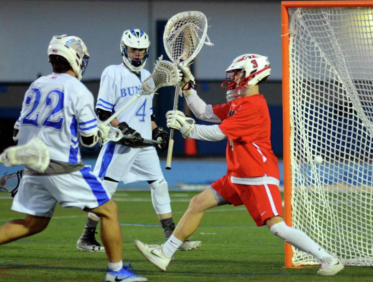 Bunnell's Davis Jarrod (22) sends the ball past Masuk goalie Christopher Tillotson (3) to score during boys lacrosse action in Stratford, Conn., on Tuesday May 1, 2018.