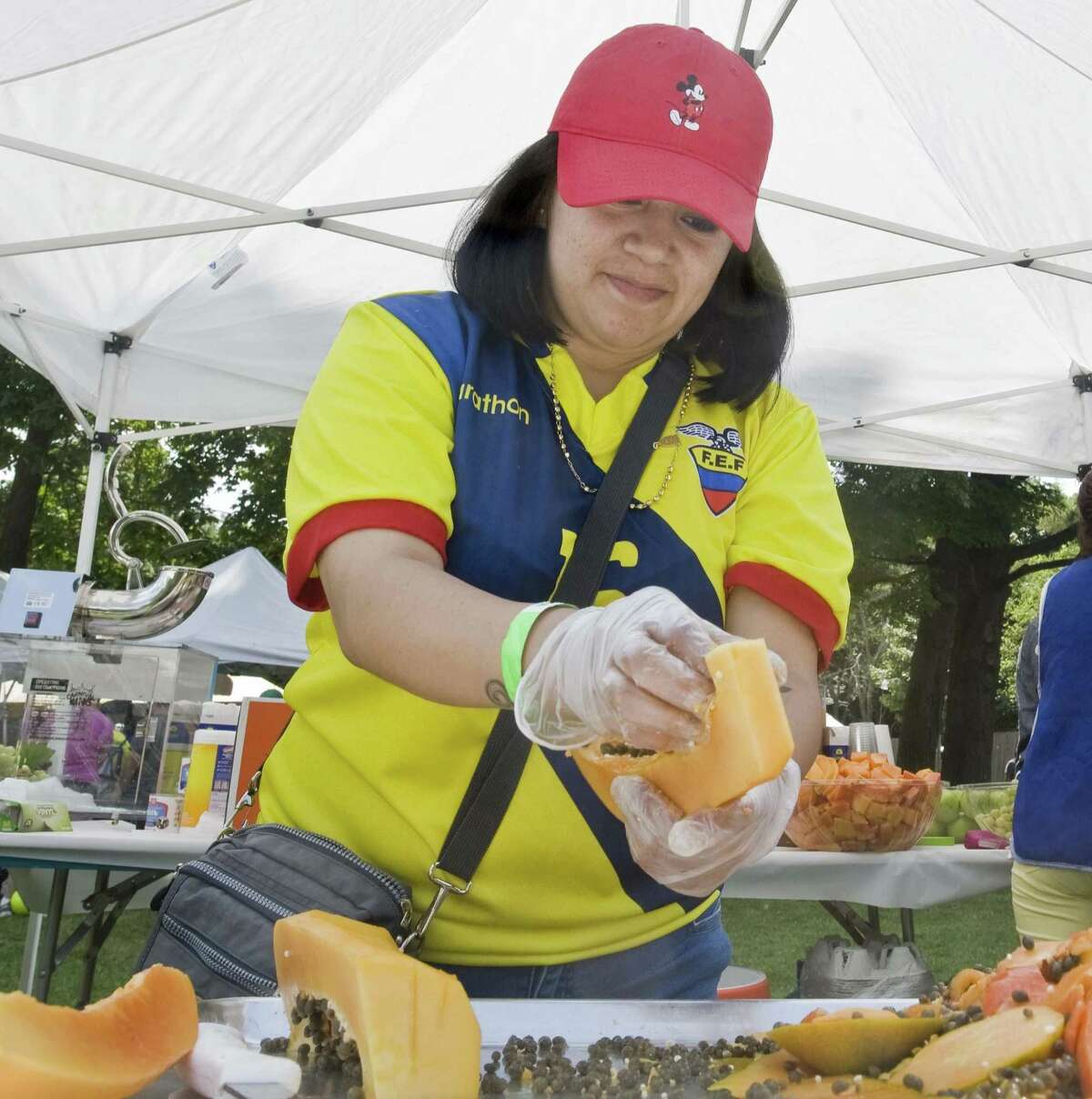 Adriana Orellana cleans papaya at the Ecuadorian Festival at the Ives Concert Park in Danbury. Sunday, Aug. 6, 2017