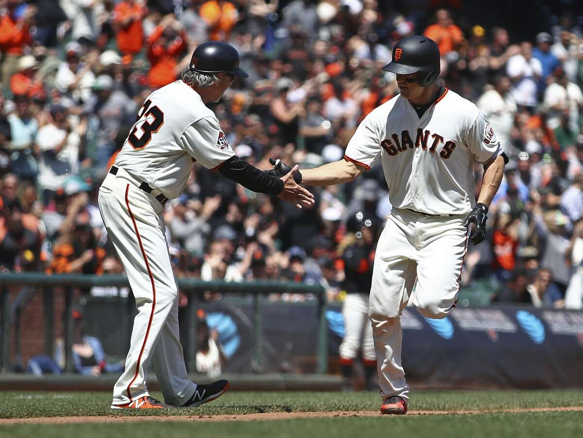 San Francisco Giants' Nick Hundley, right, is congratulated by third base coach Ron Wotus (23) after hitting a two-run home run off San Diego Padres' Clayton Richard in the fourth inning of a baseball game Wednesday, May 2, 2018, in San Francisco. (AP Photo/Ben Margot)