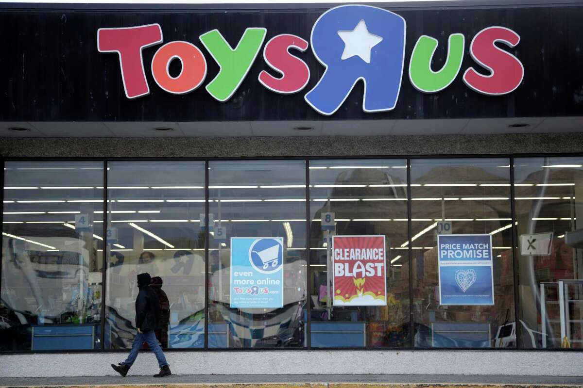 FILE- This Jan. 24, 2018, file photo shows a person walking near the entrance to a Toys R Us store, in Wayne, N.J. Canada?’s Fairfax Financial Holding has placed a bid of $300 million to buy Toys R Us?’s Canadian operations in bankruptcy. According to court papers filed late Thursday, April 19, 2018, the bidder is taking on a role of a ?“stalking horse?” in a court-approved auction set for Monday in New York. That means it could be outbid in the auction if other buyers come in with a higher offer. The bid from Fairfax surpassed the $215 million offer that Isaac Larian, the CEO of privately held toy company MGA Entertainment, made last week. (AP Photo/Julio Cortez, File)