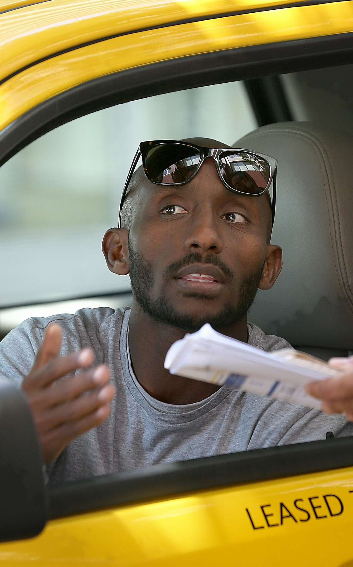 Taxi driver Daniel Habtu, 34 years old, waits for customers at Marriotts Hotel on Tuesday, March 22, 2016, in Oakland, California.