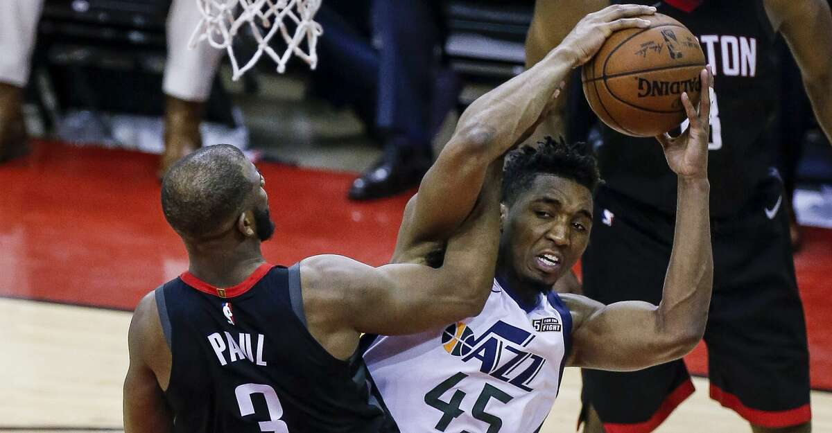 Houston Rockets guard Chris Paul (3) fouls Utah Jazz guard Donovan Mitchell (45) during the second half of Game 2 of the NBA second-round playoff series at the Toyota Center Wednesday, May 2, 2018 in Houston. (Michael Ciaglo / Houston Chronicle)
